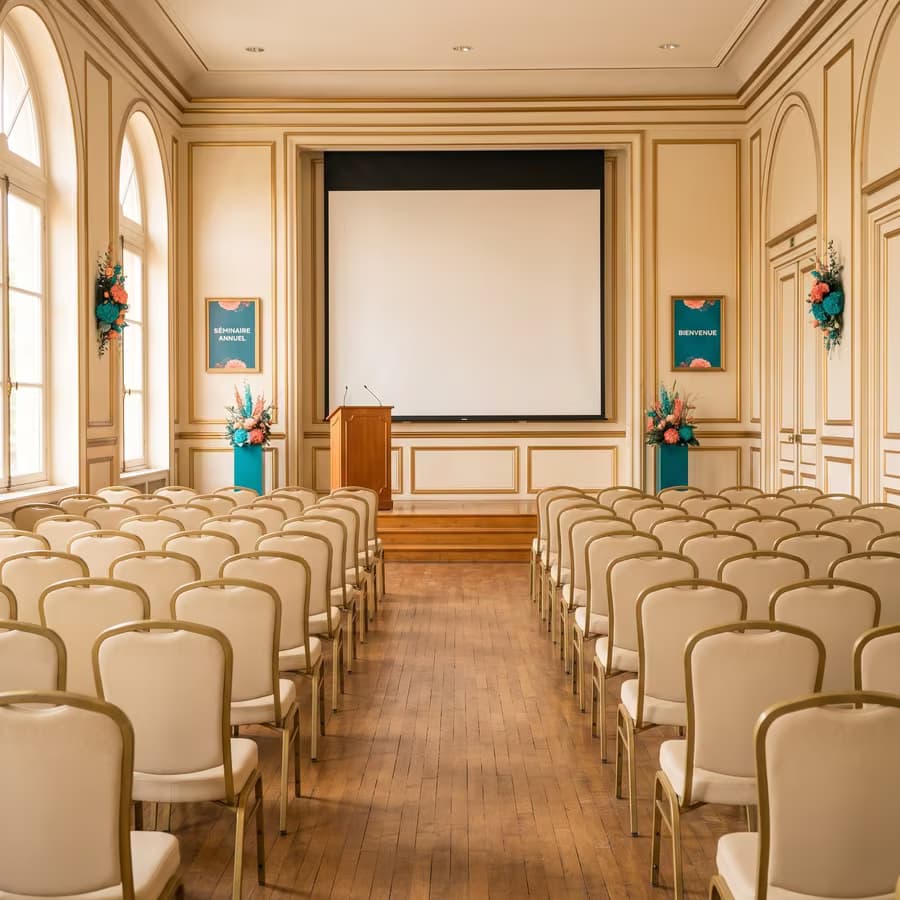 Séance plénière : salle patrimoniale, rangées de chaises, pupitre et écran